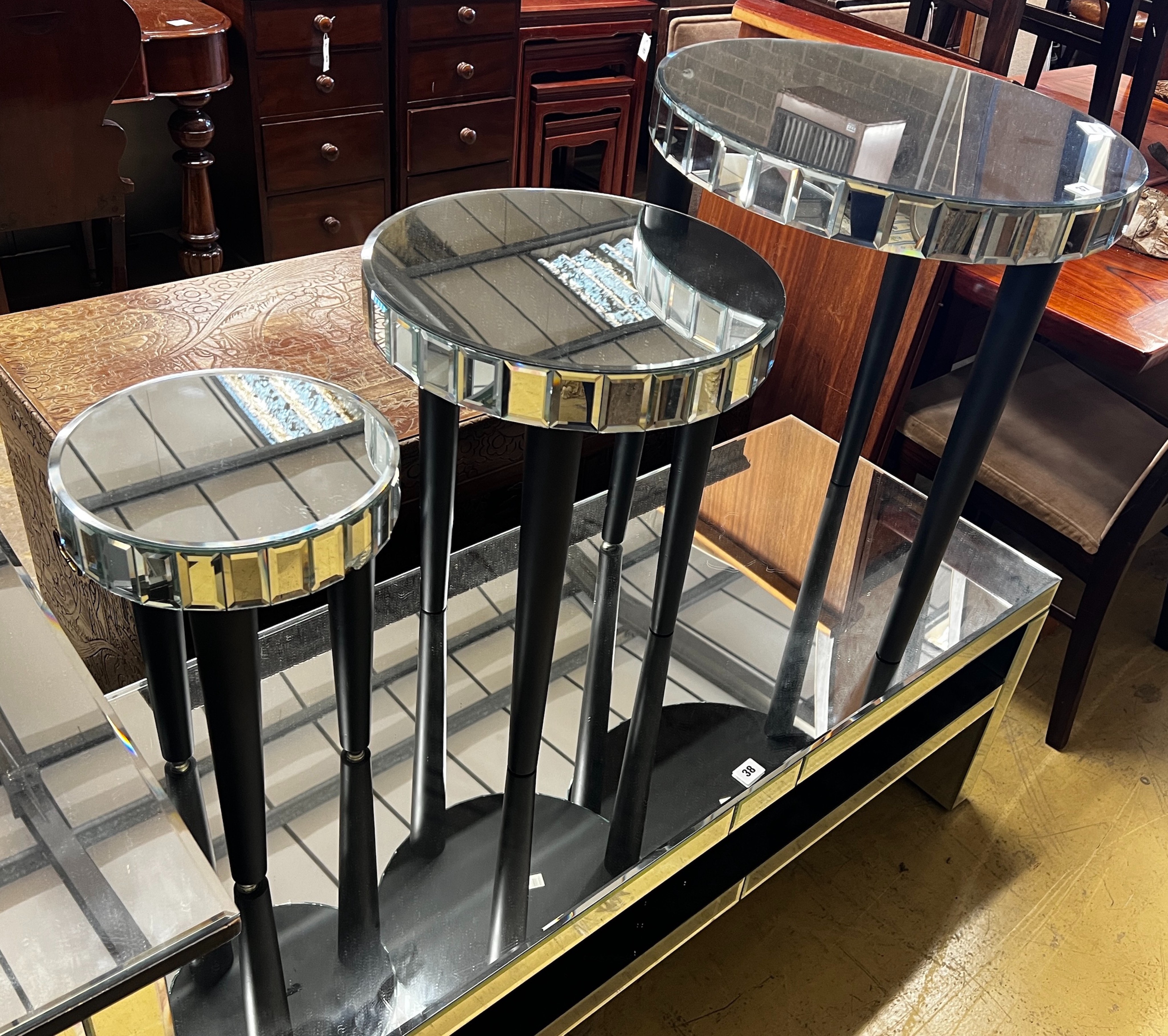 A contemporary nest of three circular mirrored occasional tables, largest diameter 51cm, height 60cm